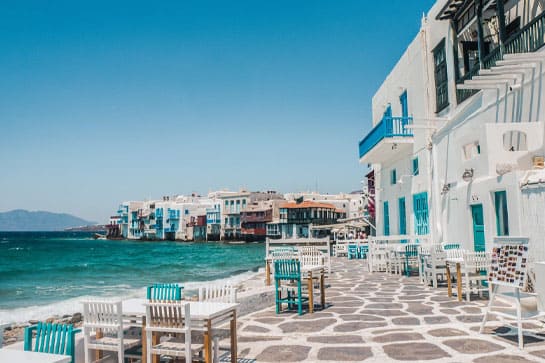 Greek Island harbor with cafe tables