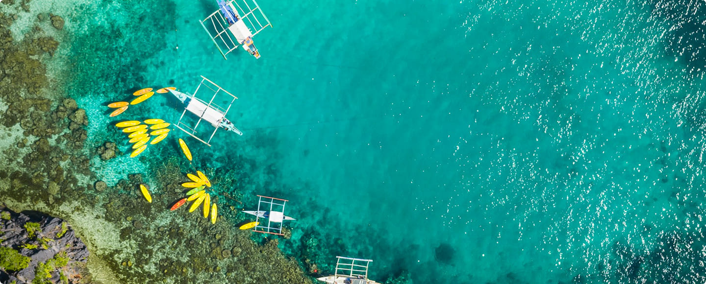 Kayaks floating over a tropical coral reef
